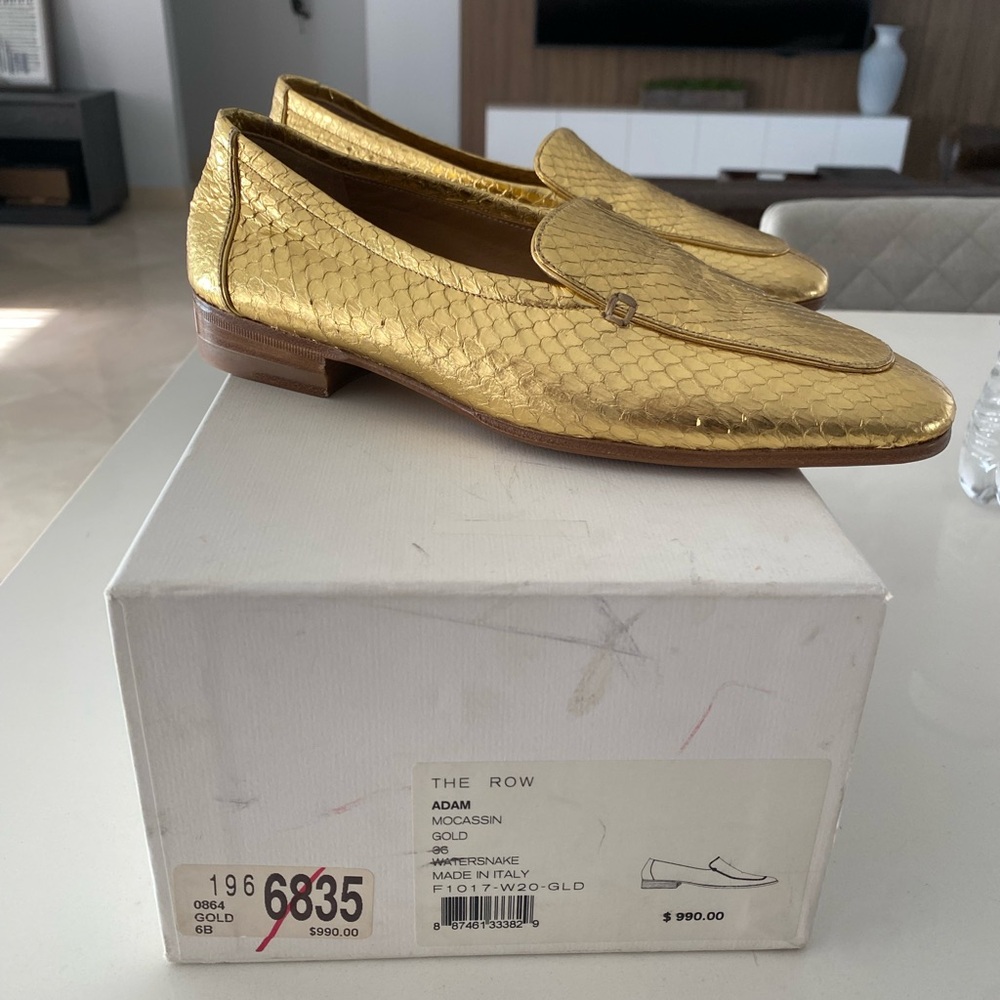 The Row gold metallic leather loafer.